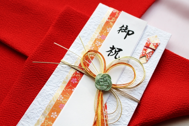 Put money in the gift envelope and hand it over.
