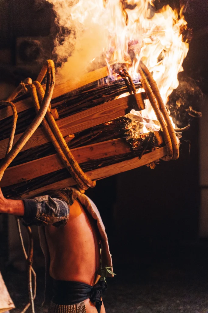 Young man holding a large torch