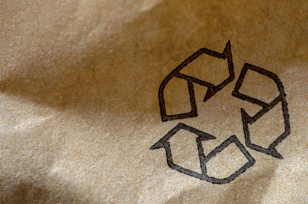 recycle symbol printed on brown recycled